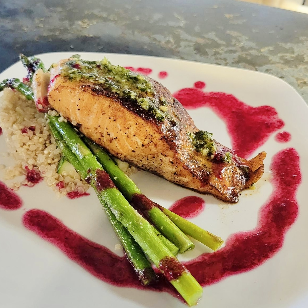 Pan-seared salmon with asparagus and berry reduction